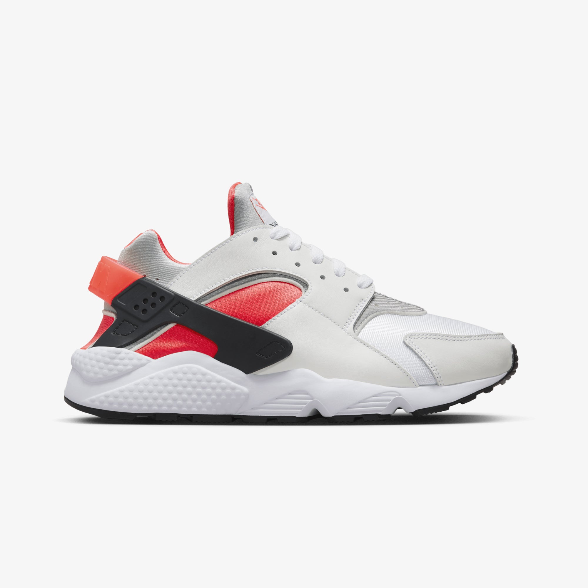 Nike Air Huarache sneakers in white, metallic silver, infrared 23, and black.