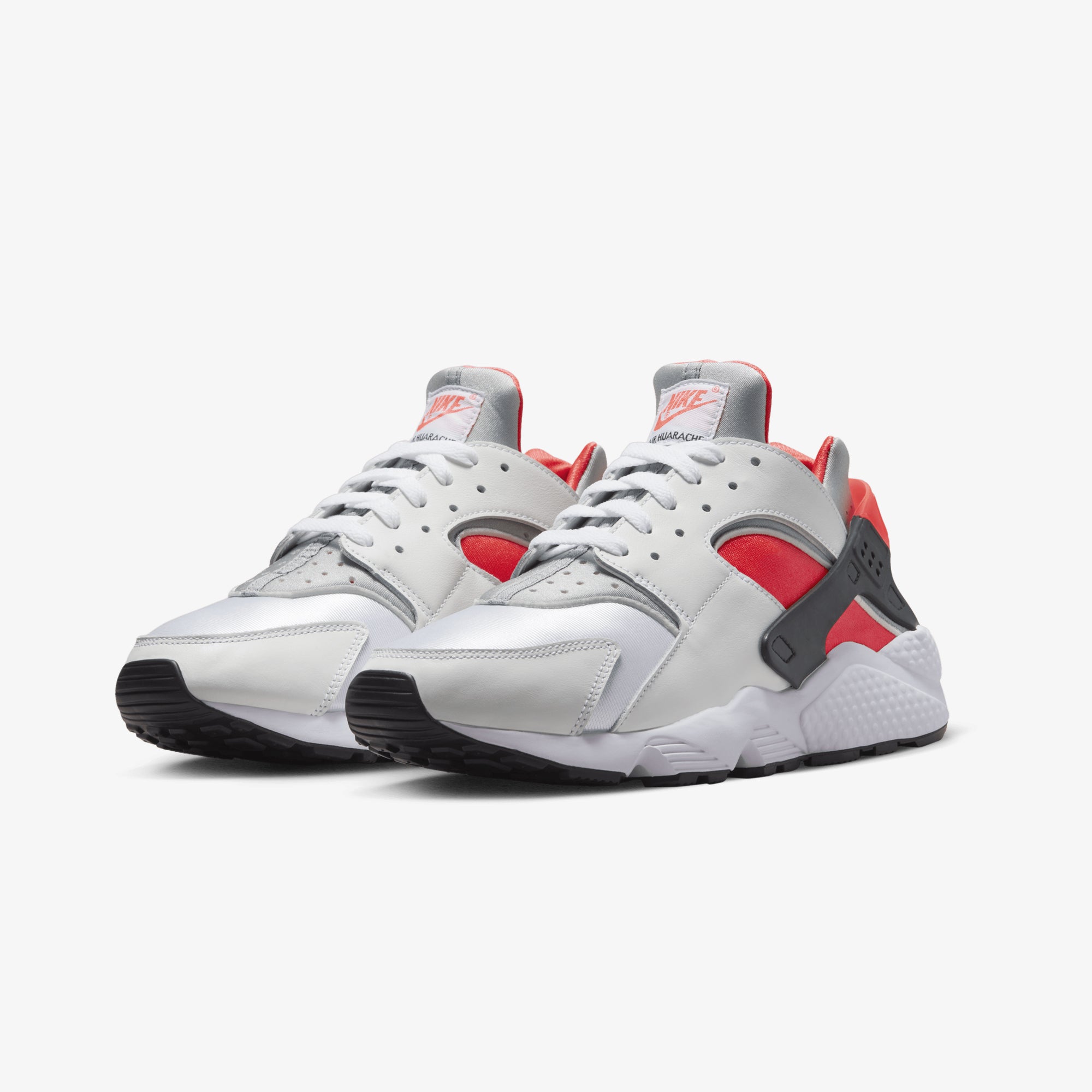 Nike Air Huarache sneakers in white, metallic silver, infrared 23, and black.