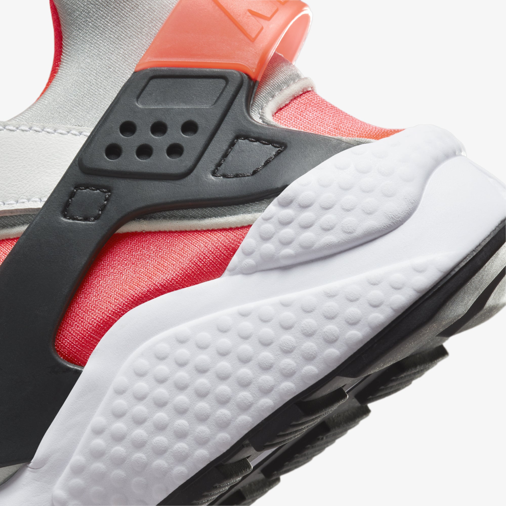 Nike Air Huarache sneakers in white, metallic silver, infrared 23, and black.